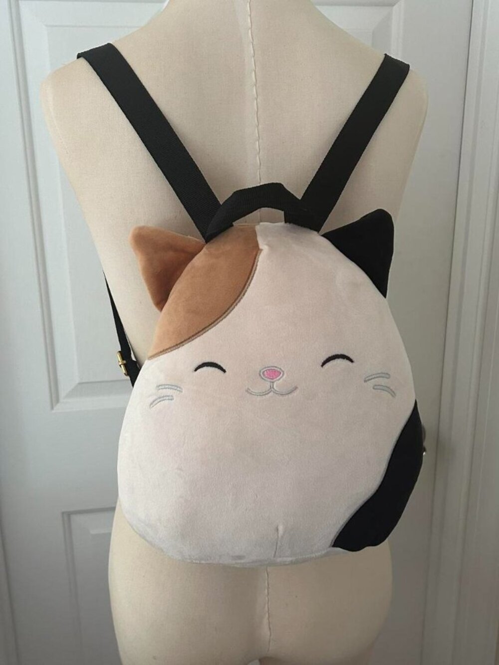 Squishmallow cat backpack with black and tan cat face design